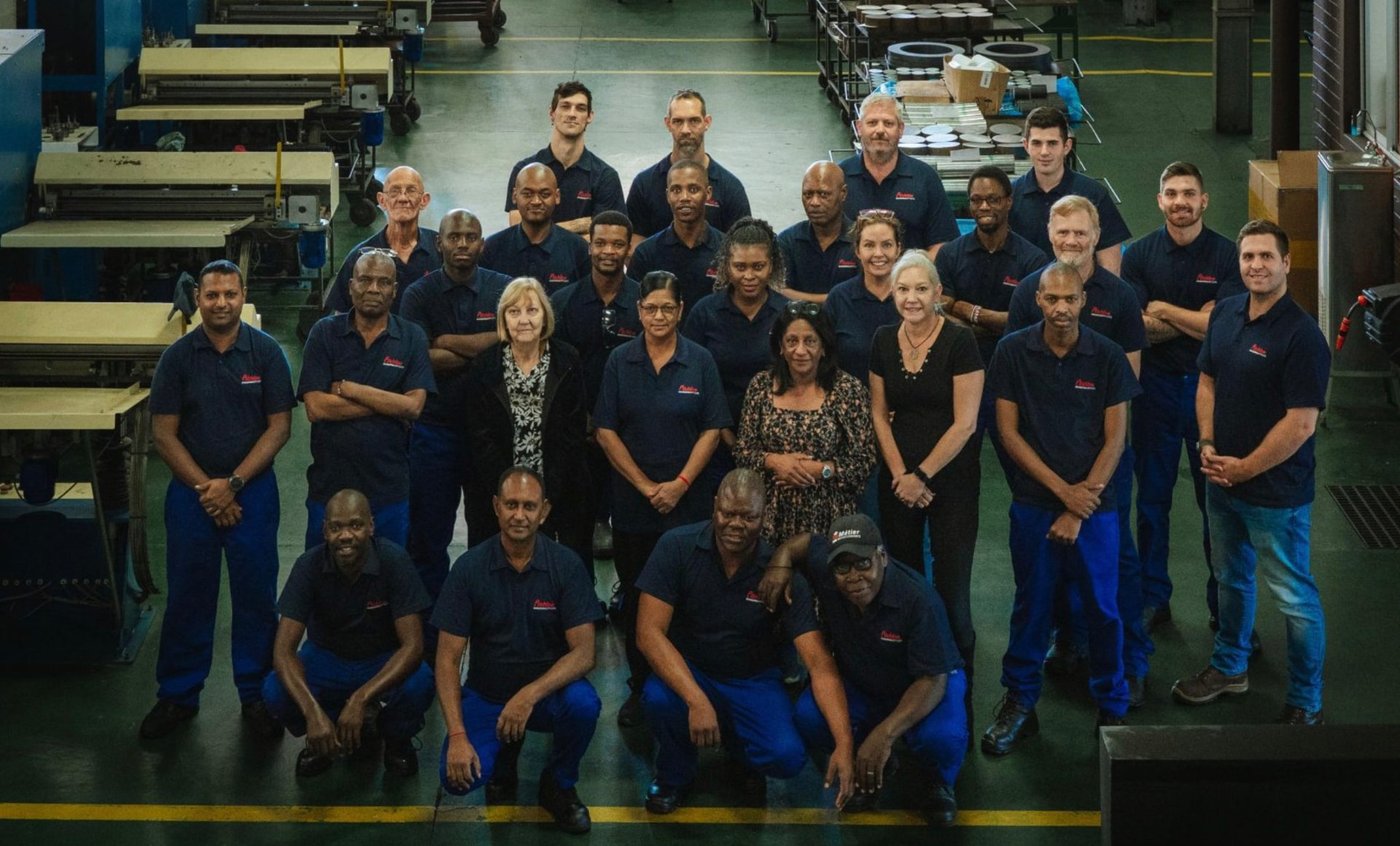 The ManuMark team gathered on the factory floor